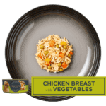Isolated aerial image of Encore chicken in broth dog food with vegetables on a plate