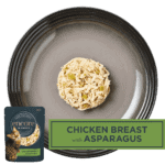 Isolated aerial image of Encore chicken cat food with asparagus on a plate